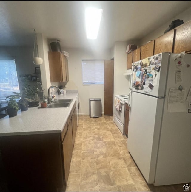 631 N 1150 W, Provo, UT 84601 - kitchen with white appliances, a sink, light countertops, brown cabinetry, and under cabinet range hood