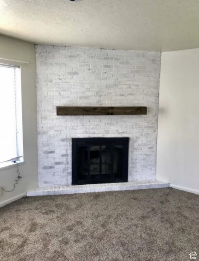 631 N 1150 W, Provo, UT 84601 - detailed view of carpet flooring, a fireplace, baseboards, and a textured ceiling