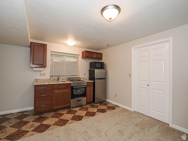 1090 E 2125 N, Layton, UT 84041 - kitchen with stainless steel appliances, baseboards, a textured ceiling, and light stone countertops