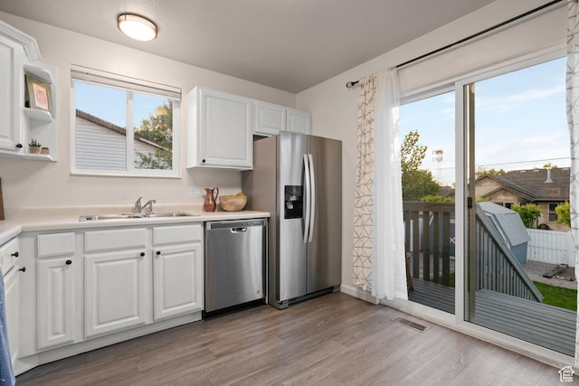 2276 W Bonniebrook Cir S, Taylorsville, UT 84129 - kitchen featuring stainless steel appliances, a sink, light wood-style floors, and healthy amount of natural light