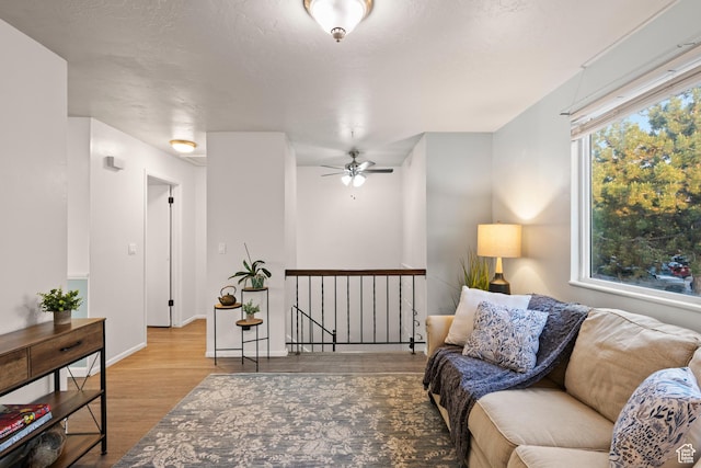 2276 W Bonniebrook Cir S, Taylorsville, UT 84129 - living room with wood finished floors, baseboards, and ceiling fan