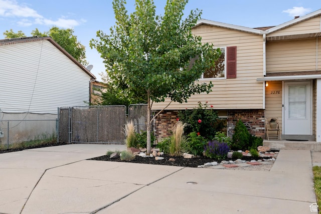 2276 W Bonniebrook Cir S, Taylorsville, UT 84129 - view of side of home featuring brick siding and a gate