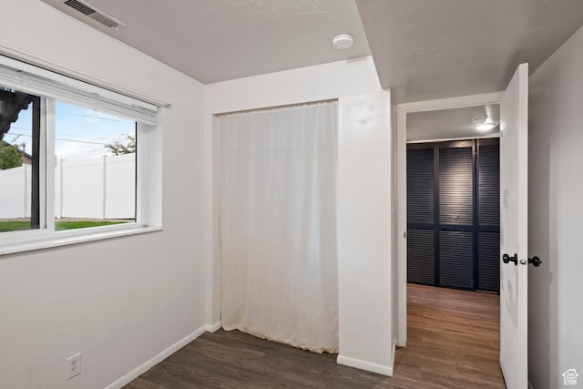 2276 W Bonniebrook Cir S, Taylorsville, UT 84129 - unfurnished bedroom with dark wood-type flooring and baseboards