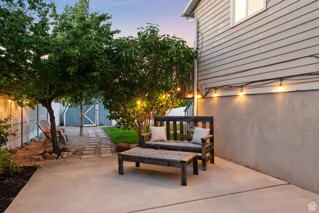 2276 W Bonniebrook Cir S, Taylorsville, UT 84129 - patio terrace at dusk featuring a patio area and a gate