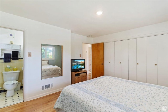2377 S 150 E, Bountiful, UT 84010 - bedroom featuring light wood-style floors, connected bathroom, a closet, and baseboards