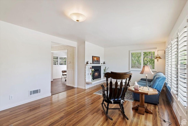 2377 S 150 E, Bountiful, UT 84010 - sitting room with a glass covered fireplace, wood finished floors, and baseboards