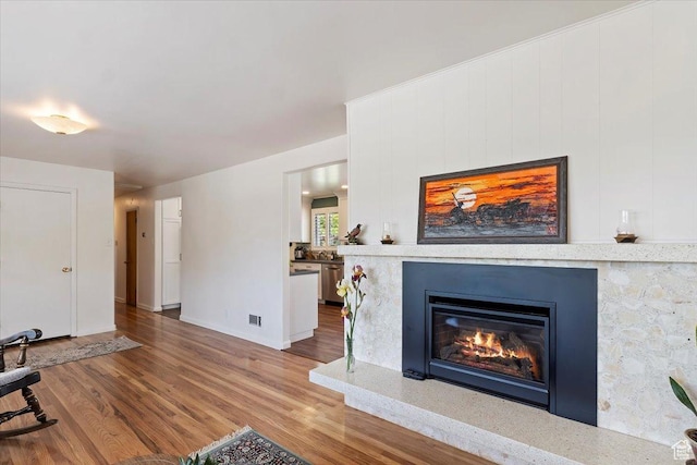 2377 S 150 E, Bountiful, UT 84010 - living area with wood finished floors, a glass covered fireplace, and baseboards