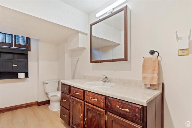 2377 S 150 E, Bountiful, UT 84010 - bathroom with wood finished floors, toilet, vanity, and baseboards