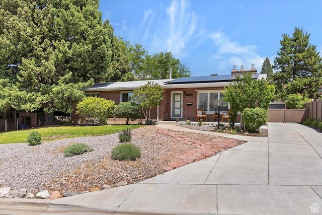 2377 S 150 E, Bountiful, UT 84010 - ranch-style house featuring brick siding, roof mounted solar panels, and driveway