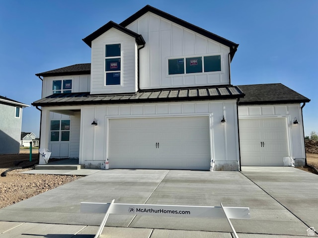 3807 W 1780 S Unit 213, Taylor, UT 84401 - view of front of home featuring board and batten siding, a standing seam roof, driveway, and a garage