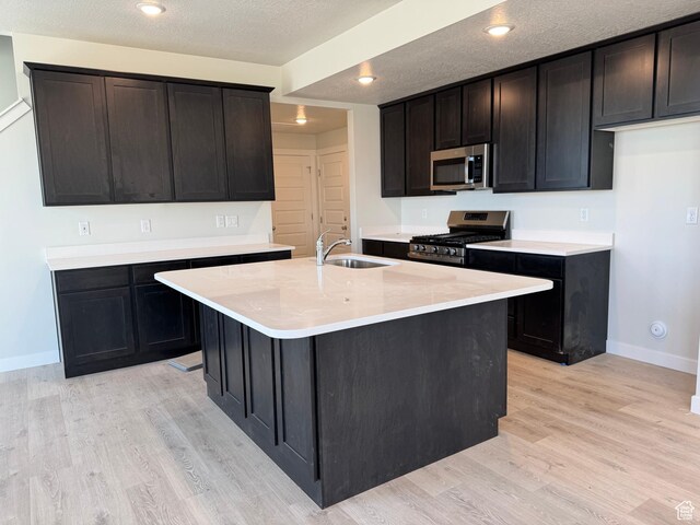 3807 W 1780 S Unit 213, Taylor, UT 84401 - kitchen with appliances with stainless steel finishes, a sink, baseboards, light wood finished floors, and light countertops