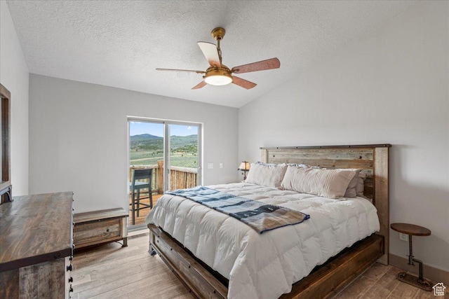 46982 W Thunder Ridge Rd, Fruitland, UT 84027 - bedroom featuring access to outside, wood finished floors, a textured ceiling, vaulted ceiling, and a ceiling fan