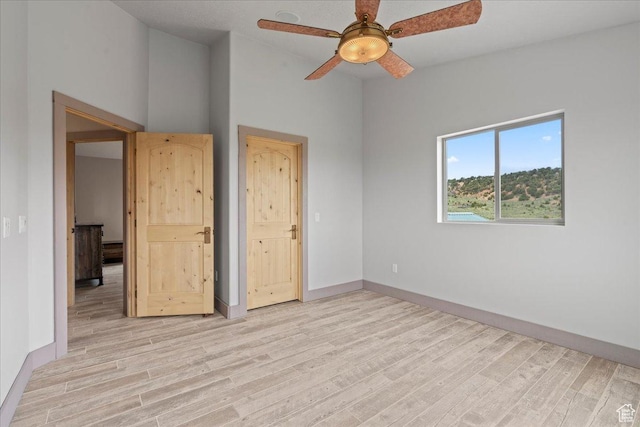 46982 W Thunder Ridge Rd, Fruitland, UT 84027 - empty room with light wood-type flooring, a ceiling fan, and baseboards