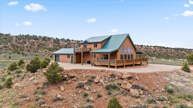 46982 W Thunder Ridge Rd, Fruitland, UT 84027 - rear view of property with log veneer siding, metal roof, a deck, and a balcony