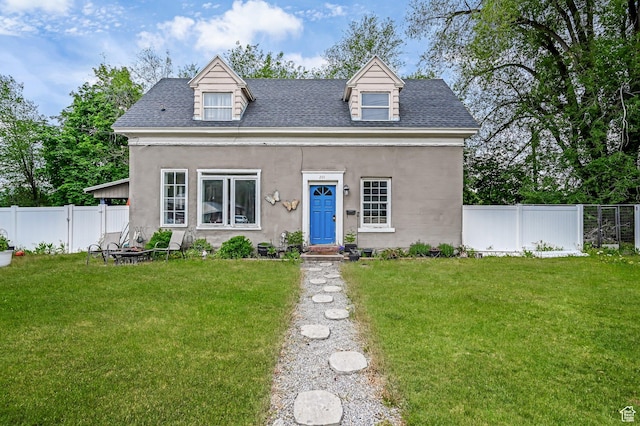 201 S 400 W, Logan, UT 84321 - cape cod-style house featuring roof with shingles, a fenced backyard, and stucco siding