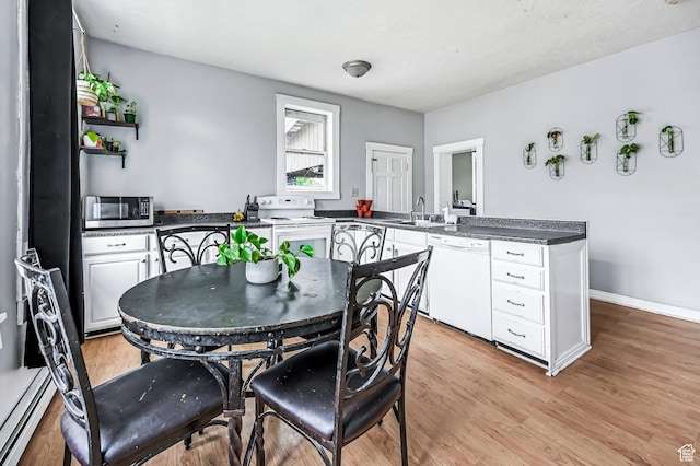 201 S 400 W, Logan, UT 84321 - dining room with light wood finished floors and baseboard heating