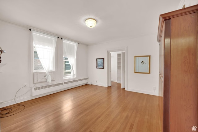 29 S State St Unit 810, Salt Lake City, UT 84111 - spare room with a baseboard heating unit, light wood-style floors, and baseboards
