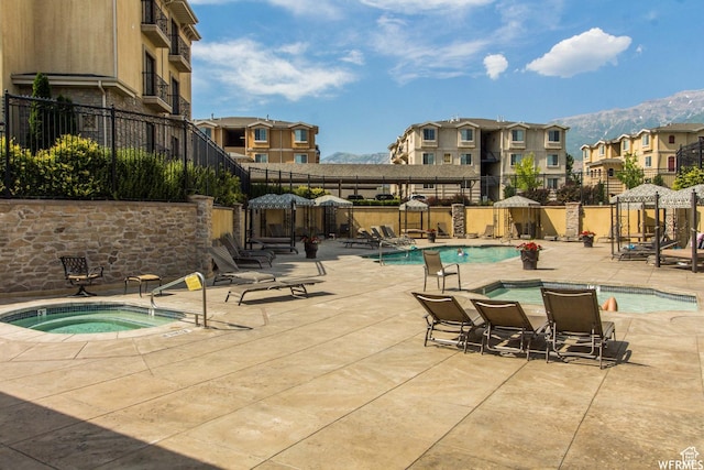1030 N 995 W Unit 907, Orem, UT 84057 - community pool featuring a hot tub, a residential view, a patio, and a mountain view