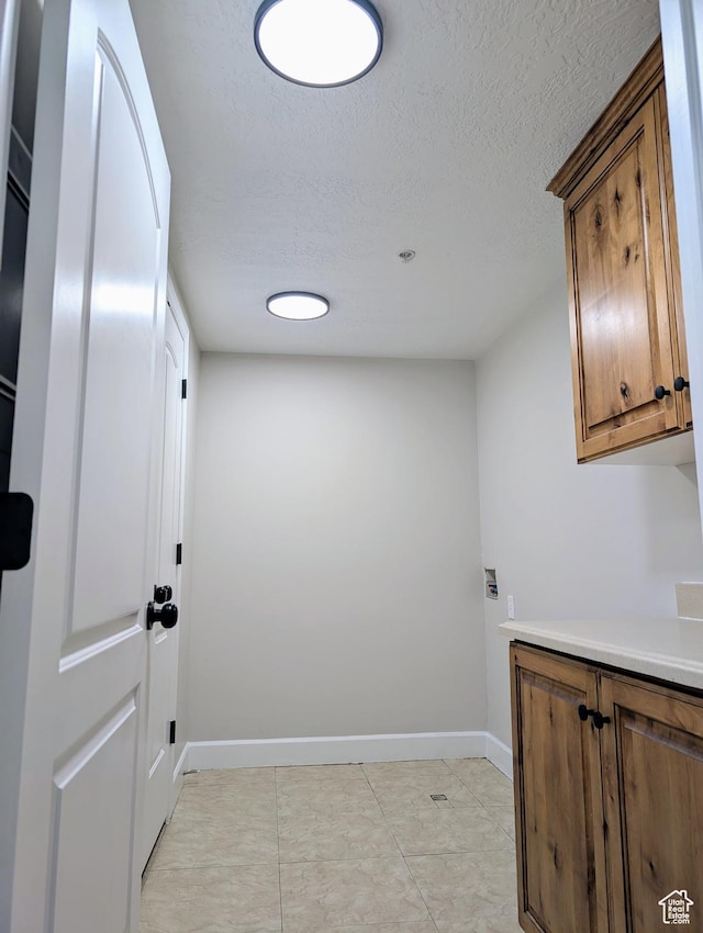 1030 N 995 W Unit 907, Orem, UT 84057 - laundry area with a textured ceiling, baseboards, and cabinet space