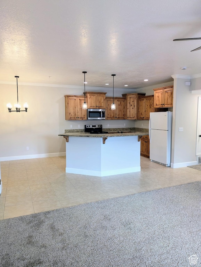 1030 N 995 W Unit 907, Orem, UT 84057 - kitchen with appliances with stainless steel finishes, a breakfast bar area, crown molding, brown cabinets, and baseboards