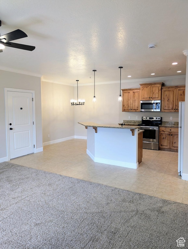 1030 N 995 W Unit 907, Orem, UT 84057 - kitchen featuring stainless steel appliances, a kitchen bar, brown cabinets, a ceiling fan, and crown molding