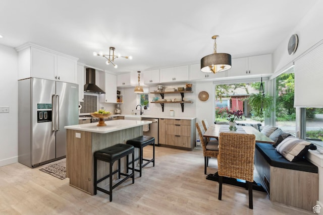 1411 S Utah St Unit 7, Salt Lake City, UT 84104 - kitchen featuring stainless steel appliances, open shelves, wall chimney range hood, light countertops, and backsplash