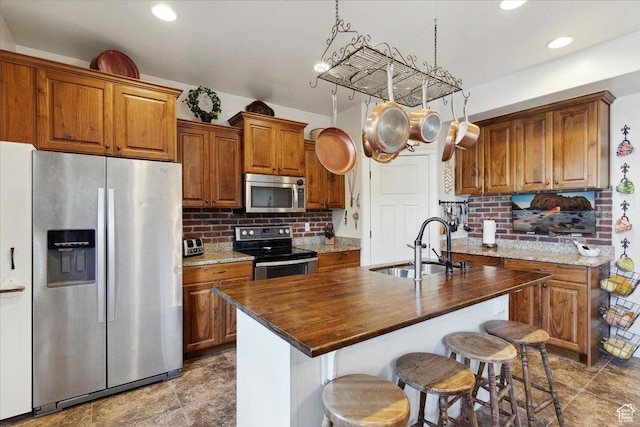255 W 2700 N Unit 31, Pleasant View, UT 84414 - kitchen with stainless steel appliances, a sink, brown cabinets, backsplash, and recessed lighting
