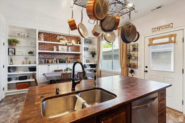 255 W 2700 N Unit 31, Pleasant View, UT 84414 - kitchen with stainless steel dishwasher, a sink, butcher block countertops, and built in features