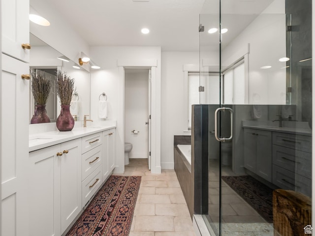 1136 E 3580 S, Millcreek, UT 84106 - full bathroom with double vanity, a bath, a shower stall, toilet, and recessed lighting