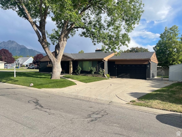 1136 E 3580 S, Millcreek, UT 84106 - single story home featuring a garage, a mountain view, driveway, and a front lawn