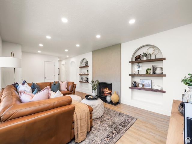 1136 E 3580 S, Millcreek, UT 84106 - living area featuring light wood finished floors, recessed lighting, a large fireplace, built in features, and baseboards