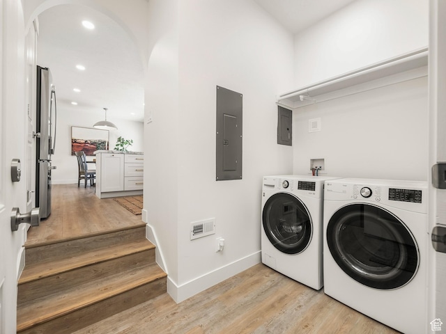 1136 E 3580 S, Millcreek, UT 84106 - laundry room featuring electric panel, arched walkways, light wood-type flooring, and recessed lighting