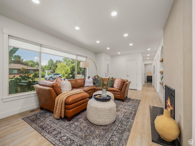 1136 E 3580 S, Millcreek, UT 84106 - living room with baseboards, recessed lighting, light wood finished floors, and a warm lit fireplace