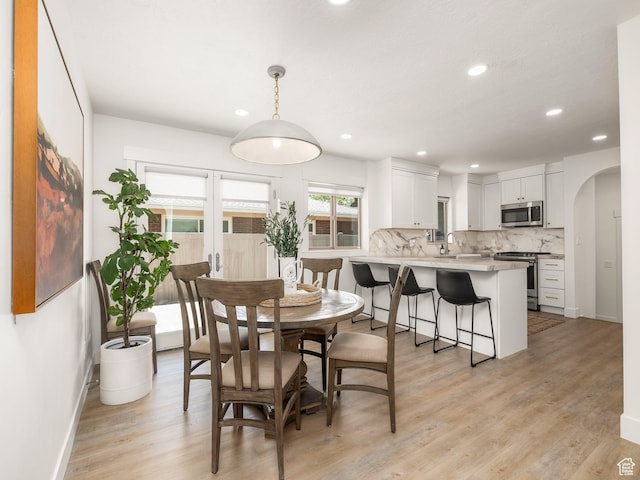 1136 E 3580 S, Millcreek, UT 84106 - dining room featuring baseboards, recessed lighting, light wood finished floors, and arched walkways