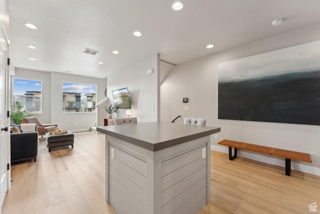 6625 Mountain Alder Way Unit 24, Park City, UT 84098 - kitchen with light wood-style floors, a center island, recessed lighting, baseboards, and dark countertops
