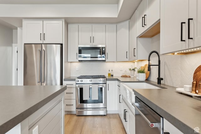 6625 Mountain Alder Way Unit 24, Park City, UT 84098 - kitchen with stainless steel appliances, a sink, white cabinets, and decorative backsplash