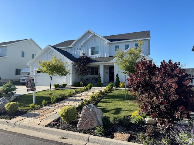 144 E Shorewood Dr S, Saratoga Springs, UT 84045 - view of front facade with board and batten siding, a front yard, driveway, and an attached garage