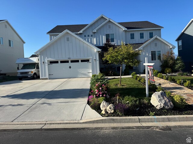 144 E Shorewood Dr S, Saratoga Springs, UT 84045 - view of front of property with board and batten siding, concrete driveway, and an attached garage