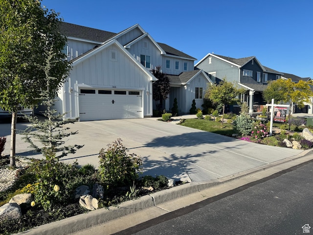 144 E Shorewood Dr S, Saratoga Springs, UT 84045 - view of front of property with board and batten siding, concrete driveway, an attached garage, and a residential view