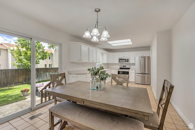 8328 S Grambling Way, Sandy, UT 84094 - dining room featuring light tile patterned floors, a chandelier, a skylight, and baseboards