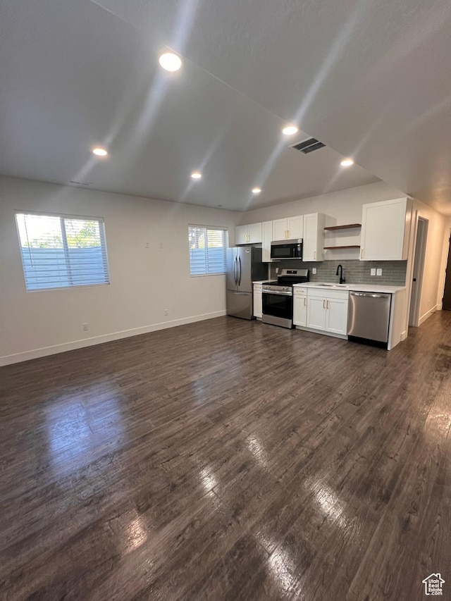 502 N 450 W, Orem, UT 84057 - kitchen with appliances with stainless steel finishes, a sink, white cabinetry, baseboards, and dark wood-style flooring