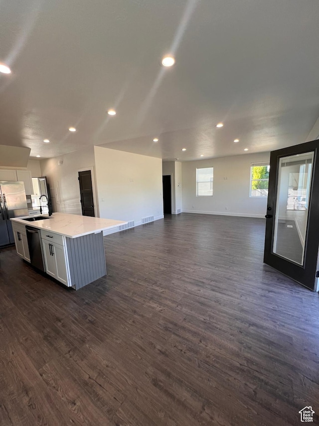 502 N 450 W, Orem, UT 84057 - kitchen featuring stainless steel appliances, white cabinets, a kitchen island with sink, open floor plan, and dark wood-type flooring