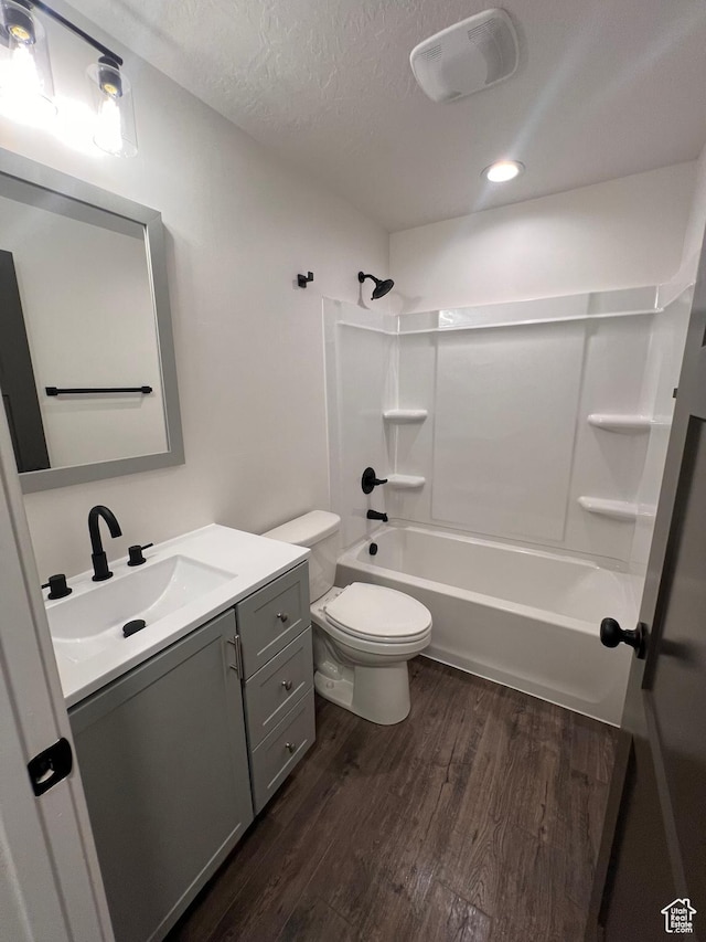 502 N 450 W, Orem, UT 84057 - bathroom featuring wood finished floors, toilet, vanity, a textured ceiling, and shower / washtub combination