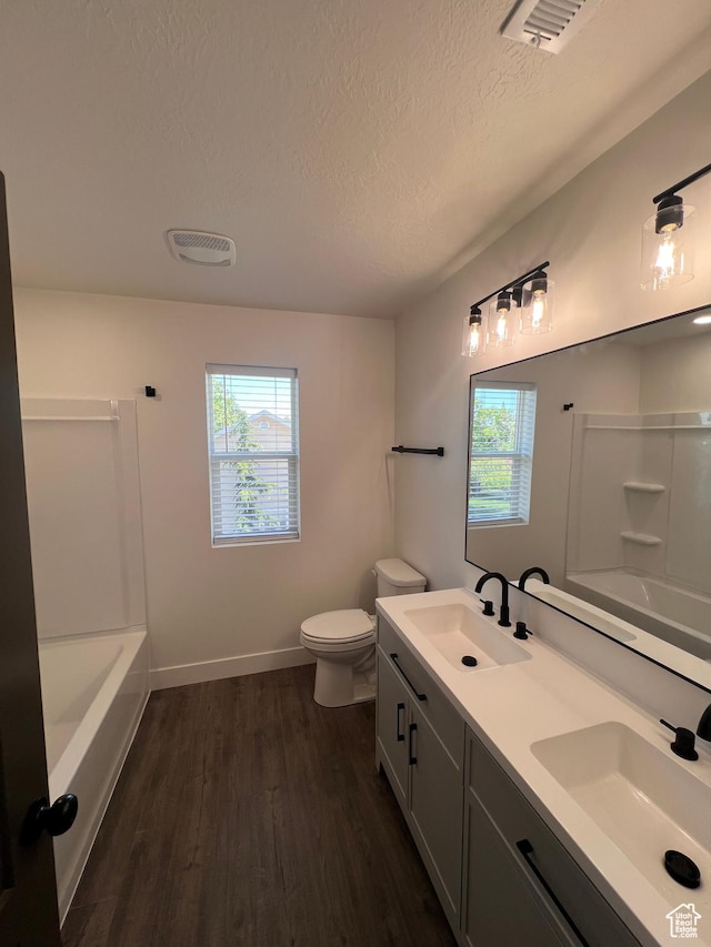 502 N 450 W, Orem, UT 84057 - bathroom featuring a textured ceiling, wood finished floors, toilet, double vanity, and baseboards