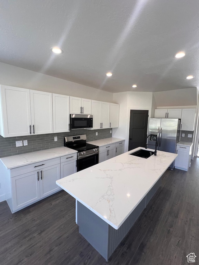 502 N 450 W, Orem, UT 84057 - kitchen featuring stainless steel appliances, a sink, dark wood-type flooring, white cabinetry, and backsplash