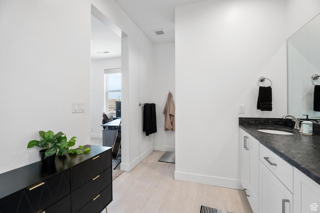 5670 S Carnelian Pkwy S, Bloomington, UT 84790 - bathroom featuring wood finished floors, baseboards, and vanity