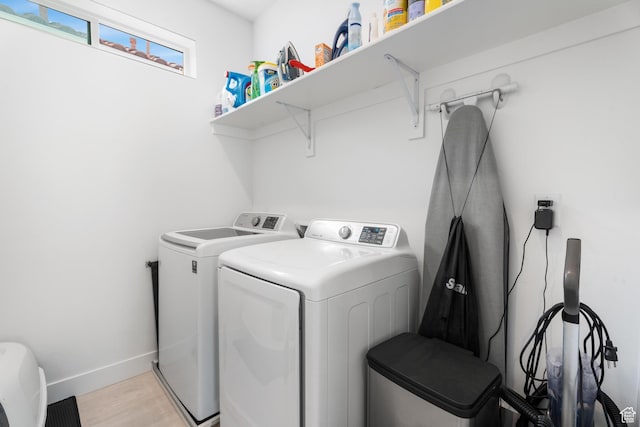 5670 S Carnelian Pkwy S, Bloomington, UT 84790 - laundry area with washer and clothes dryer, light wood-style flooring, and baseboards