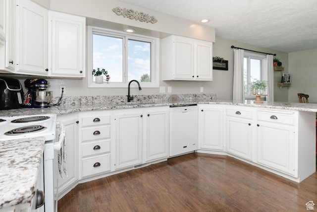 3704 S State St, Preston, ID 83263 - kitchen featuring white appliances, a sink, a peninsula, white cabinetry, and a textured ceiling