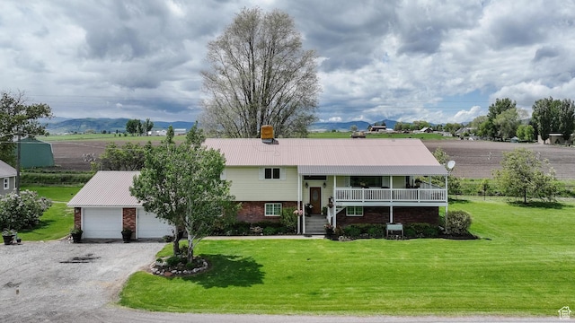 3704 S State St, Preston, ID 83263 - view of front of house with brick siding, a front lawn, a garage, and metal roof