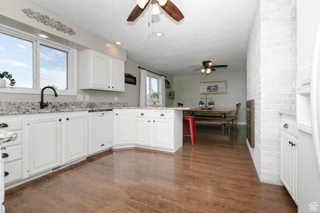 3704 S State St, Preston, ID 83263 - kitchen with ceiling fan, white appliances, a peninsula, white cabinetry, and a textured ceiling